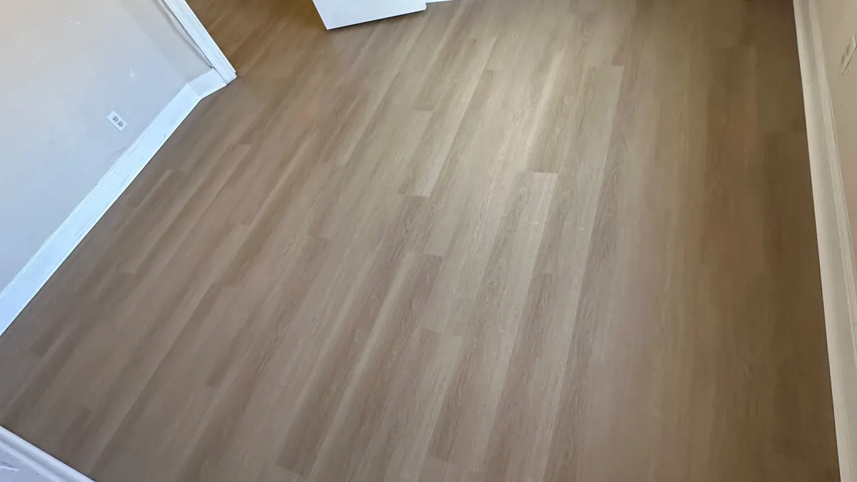 Finished wood-look flooring installation in a bedroom