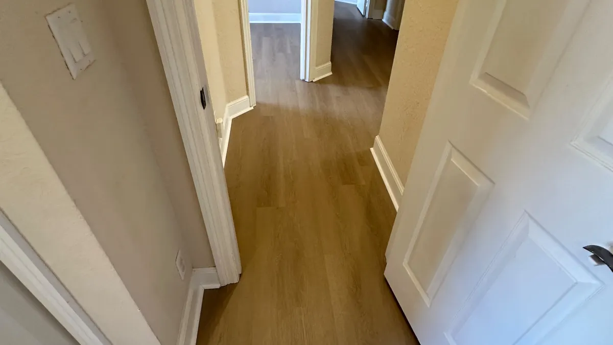 Finished wood-look flooring installation in a hallway