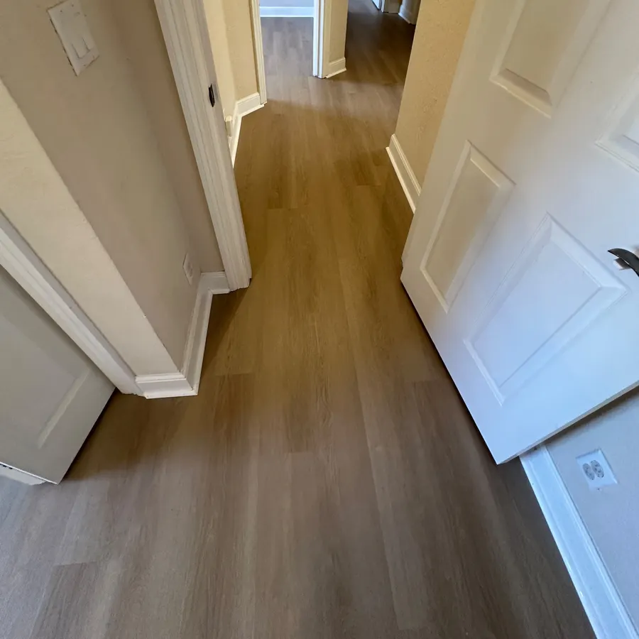 Finished wood-look plank flooring running through a hallway