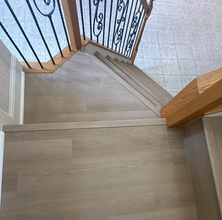 Wood-look flooring installed on a stair landing